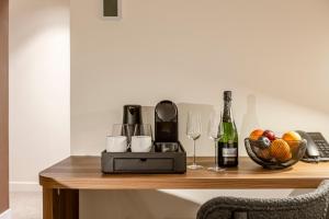 a table with wine glasses and a basket of fruit at Le Madame By Sweett in Paris
