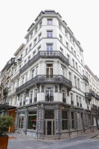 a white building with balconies on the side of it at The Mila Brussels in Brussels +51 photos
