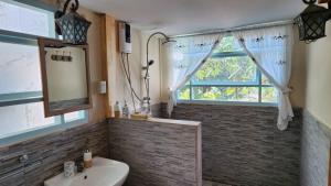 a bathroom with a toilet and a sink and a window at Flora Prairie at Mae Rim, Chiang Mai in Ban Tai +67 photos