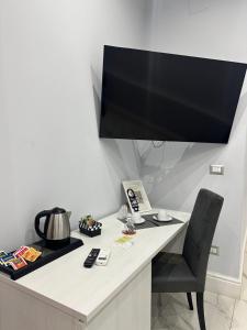 a desk with a large television on top of it at luxury 2.0 in Naples +17 photos