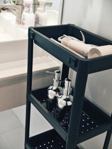 a black rack with complimentary products in a bathroom at Fivehouse Silom1 - City heart - Silom -BTS MRT 2min - lumpini park - bnh in Bangkok +91 photos
