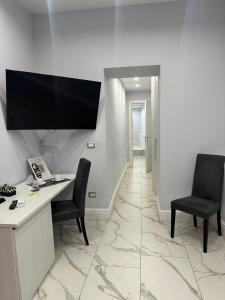 an office with a desk and two chairs and a television at luxury 2.0 in Naples