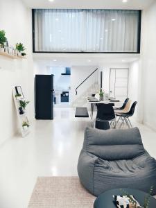 a living room with a couch and a table at Fivehouse Silom1 - City heart - Silom -BTS MRT 2min - lumpini park - bnh in Bangkok