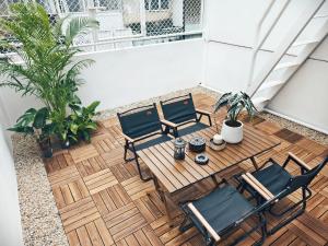 an overhead view of a patio with two chairs and a table at Fivehouse Silom1 - City heart - Silom -BTS MRT 2min - lumpini park - bnh in Bangkok