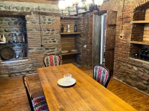 a wooden table and chairs in a room at Hotel Tao in Telavi +64 photos