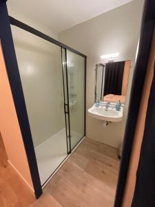 a bathroom with a glass shower and a sink at Tavarn Ty Gar in Hennebont +28 photos