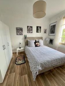 a bedroom with a bed with a comforter on it at F2 parking Gare in Melun