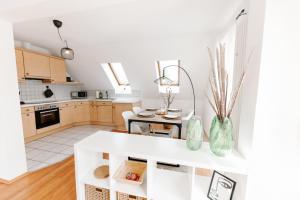 a kitchen with white cabinets and a white counter top at ERB02 - Ferienwohnung - Altstadtliebe in Michelstadt in Michelstadt +12 photos