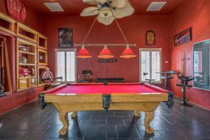a pool table in a room with red walls at 438 Indoor Pool with a Theater Room in Homestead Meadows South