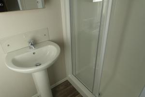 a bathroom with a sink and a shower at Red Lion Leisure Park in Arbroath +62 photos