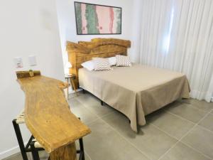 Cama ou camas em um quarto em Banzai Brava Suítes