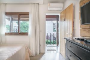 Cama ou camas em um quarto em Banzai Brava Suítes