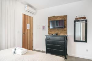 Cama ou camas em um quarto em Banzai Brava Suítes