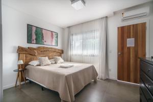 Cama ou camas em um quarto em Banzai Brava Suítes