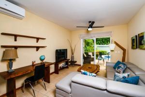TV a/nebo společenská místnost v ubytování Beach-Walkable Poolside Condo