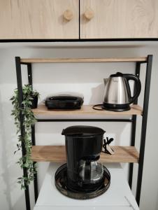 a coffee maker on a shelf in a kitchen at Tiny Japan in Volos
