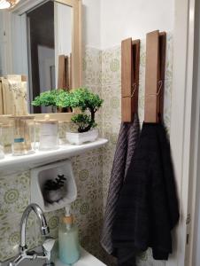 a bathroom with a sink and a mirror at Tiny Japan in Volos