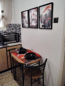 a kitchen with a table with two glasses on it at Tiny Japan in Volos +13 photos