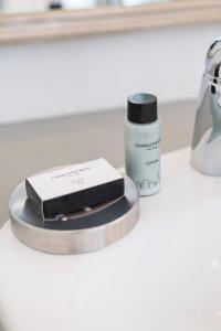 a counter top with a bottle of concealer and asensitive at Casa Velasur, De Waterkant in Cape Town
