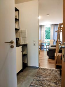 a room with a kitchen and a living room at Zentrale Apartment in der Stadt Freiburg in Freiburg im Breisgau