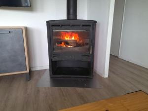 a fireplace in a living room with fire in it at Saint-Pol family house garden fully equipped 12 people in Saint-Pol-de-Léon +19 photos