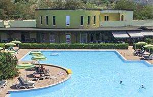 a large pool with chairs and umbrellas in front of a building at Casa 79 G in Pizzo +7 photos