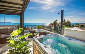 a hot tub on the balcony of a house at 3 Bedroom Awesome Apartment In Kozino in Kožino +29 photos