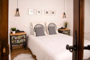 a bedroom with two beds and two night stands at Casa Cueva Luna in Orce