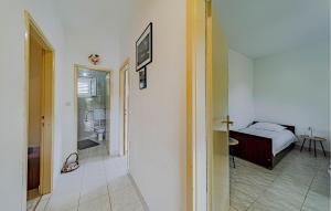 a bedroom with a bed and a walk in shower at Gorgeous Home In Zrnovo in Žrnovo +17 photos