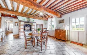a kitchen and dining room with a table and chairs at Lovely Home In Foulbec With Wifi in Foulbec