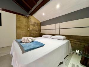 a bedroom with a bed with a towel on it at Espaço Verano - Suíte Master 2 in Niterói