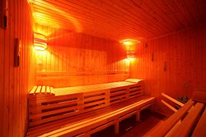 a wooden sauna with benches and lights in it at Gästehaus am schmalen See UG haftungsbeschränkt in Lauchhammer