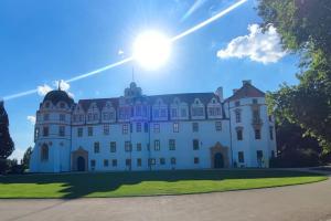 a large white castle with the sun in the sky at Hehlentor in Celle