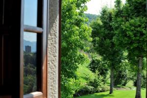 a window with a view of a field and trees at Villa Montermoli Tuskany in Santa Maria