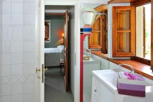 a bathroom with a sink and a room with a bed at Villa Montermoli Tuskany in Santa Maria