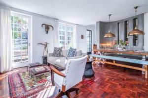 a living room with a couch and a table at Casa Velasur, De Waterkant in Cape Town