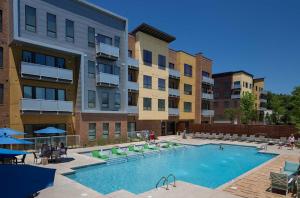 a large swimming pool in front of a building at Green Stone in Greenville
