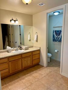 a bathroom with a sink and a mirror and a toilet at Peace in the Pines in Flagstaff +12 photos