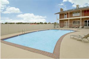 a large swimming pool in front of a building at Americas Best Value Inn Greeley in Evans