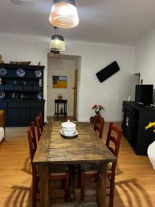 a dining room with a wooden table and chairs at Avis Guesthouse in Évora +23 photos
