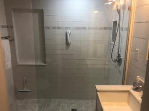 a bathroom with a shower with a sink and a tub at Somewhere In Time in Cedar +20 photos