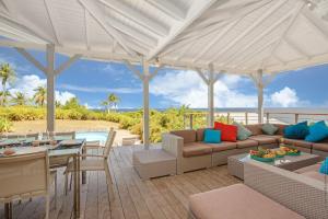 an outdoor patio with a couch and a table and a pool at Yin & Yang in Sainte-Anne