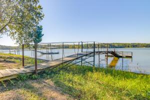 FaxonLakefront New Concord Paradise with Screened Porch!的湖上码头,上面有两艘船