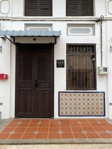 a pair of doors on a white building at Heritage Villa by Aayu - 10 mins walk to Armenian St in George Town