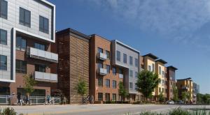 a row of buildings with people walking on a street at Green Stone in Greenville