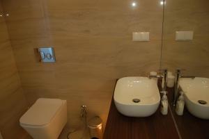 a bathroom with a toilet and a sink at Alvor Sunset in Alvor