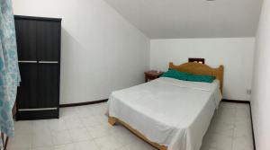 a bedroom with a bed and a black door at Safia in Trou aux Biches