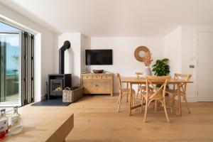a dining room with a table and a fireplace at Ocean Reach, Stunning Sea View and Balcony, 2 BR, 2 BA, Parking in Lynmouth