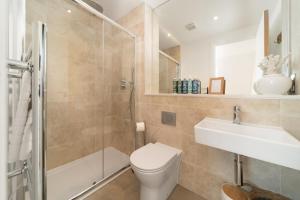 a bathroom with a toilet and a sink and a shower at Ocean Reach, Stunning Sea View and Balcony, 2 BR, 2 BA, Parking in Lynmouth
