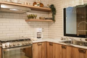 a kitchen with a sink and a stove top oven at Casa Lomas in Oaxaca City